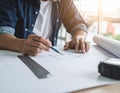 Man drawing technical plan with pencil ruler and rolled paper Royalty Free Stock Photo