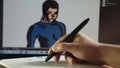 Man draws on graphic tablet in Photoshop