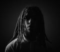 Man with dreadlocks in dramatic black and white lighting Royalty Free Stock Photo
