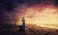 Man dreamer standing with suitcase on the rooftop of a skyscraper planning his next holiday destination Royalty Free Stock Photo