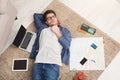 Man dreaming about travel, lying on floor Royalty Free Stock Photo