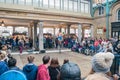 Man dress like clown riding wheelbarrow performing in the Covent Garden Market