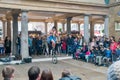 Man dress like clown riding wheelbarrow performing in the Covent Garden Market