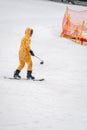 Man dressed as giraffe on a snowboard