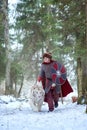 Medieval warrior walks with white tiger in forest