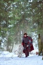 Medieval warrior walks with white tiger in forest