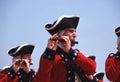 A man dressed as a revolutionary soldier plays a flute