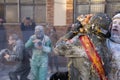 A man dressed as a soldier smashes a tray of eggs in another person's face in a battle with flour and eggs
