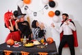 Man dressed as vampire scaring people at a costume Halloween party. Royalty Free Stock Photo
