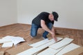 Man dressed casual assembling furniture in new house. Carpenter repair and assembling furniture at home