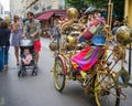 Man dressed in a costume resembling Jules Verne rides his cycle in the streets of Marais