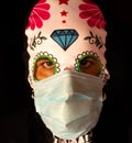 Man dressed for Halloween with a Mexican mask with a Covid19 face mask