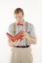 Man dressed like nerd reading. Royalty Free Stock Photo