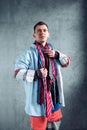 Man dressed in many clothes choosing tie