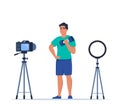 Man dressed in sports clothes does exercises with dumbbells recording video with camera on tripod. Social network blogging,