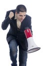 Man dressed in suit and tie shouting through megaphone. Royalty Free Stock Photo