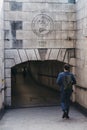 Man dressed in a suit walking towards Duke of Wellington entrance to Hyde Park Corner Subway, London, UK