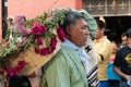 Man dressed with traditional clothes and carrying a basket with flowers and a turkey Little girl dressed with traditional clothes