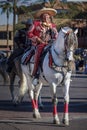 Man dressed in traditional Mexican clothing and mounted on a horse in the Scottsdale Parada Del Sol which is advertised as the