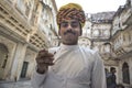 Man dressed in traditional Rajasthani clothing. With multicolored Pagri turban , Angrakha and Dhoti / Pajamas