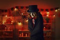 Man dressed up in top hat and cloak to look like evil vampire at Halloween horror party Royalty Free Stock Photo
