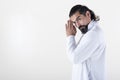 A man dressed in white clasping hands while looking at camera over white background. .Tadasana yoga pose.  Copy space Royalty Free Stock Photo