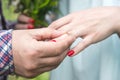 A man dresses an engagement ring for a girl on the ring finger of her left hand Royalty Free Stock Photo