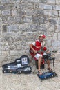 Man dressing in medieval period costume, singing at guitar. Dubrovnik, Croatia