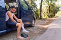 man dressing sitting on his van to go cycling
