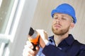 man drilling hole in window frame Royalty Free Stock Photo