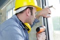 man drilling hole in window frame Royalty Free Stock Photo