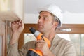 man drilling hole in window frame Royalty Free Stock Photo