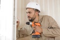man drilling hole in window frame Royalty Free Stock Photo