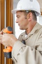 man drilling hole in window frame Royalty Free Stock Photo