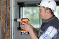 man drilling wall with drill perforator Royalty Free Stock Photo