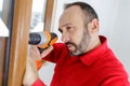 Man drilling window Royalty Free Stock Photo