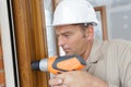 man drilling window frame Royalty Free Stock Photo