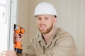 man drilling window with impact drill Royalty Free Stock Photo