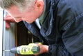 A man drills with a drill, accumulator.. Power of electric screwdriver. Close up