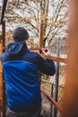 Man drills a hole in a wooden board with a boring machine Royalty Free Stock Photo