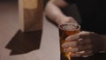 Man drink apple cider with chips on walnut table Royalty Free Stock Photo