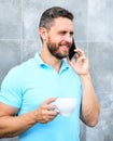 Man drink cappuccino speak phone grey wall background. Coffee can be endlessly reimagined make something old new again Royalty Free Stock Photo