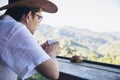 Man drink hot tea with green hill background Royalty Free Stock Photo