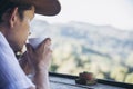 Man drink hot tea with green hill background Royalty Free Stock Photo