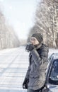 Man drink tea from mug outdoor on winter road Royalty Free Stock Photo