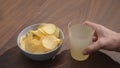 man drink lemonade with chips on walnut table Royalty Free Stock Photo