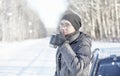 Man drink tea from mug outdoor on winter road Royalty Free Stock Photo