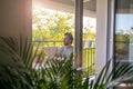 Man drinking coffee on the balcony of his apartment Royalty Free Stock Photo