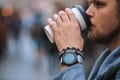 man drinking coffee from disposable cup smart watch with bracelet on wrist Royalty Free Stock Photo