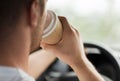 Man drinking coffee while driving the car Royalty Free Stock Photo